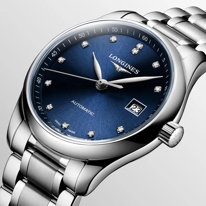 Longines watch with blue dial and silver bracelet on a light gray background