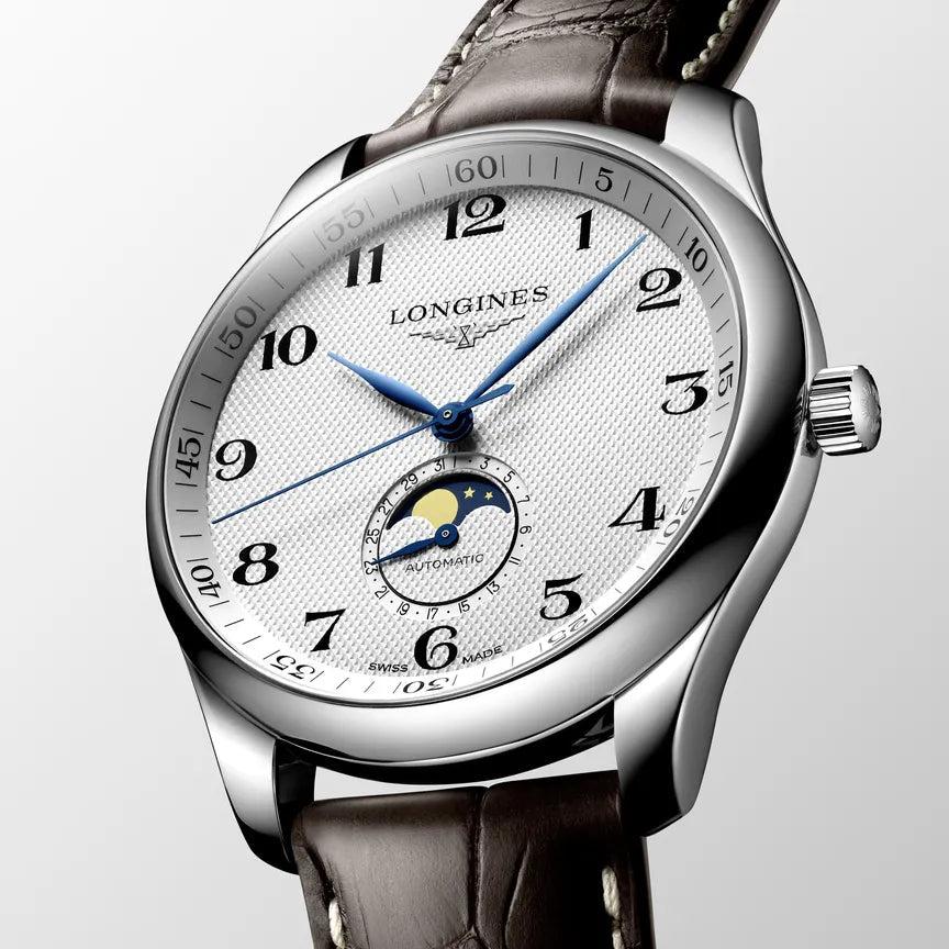 Longines watch with brown leather strap on a light gray background