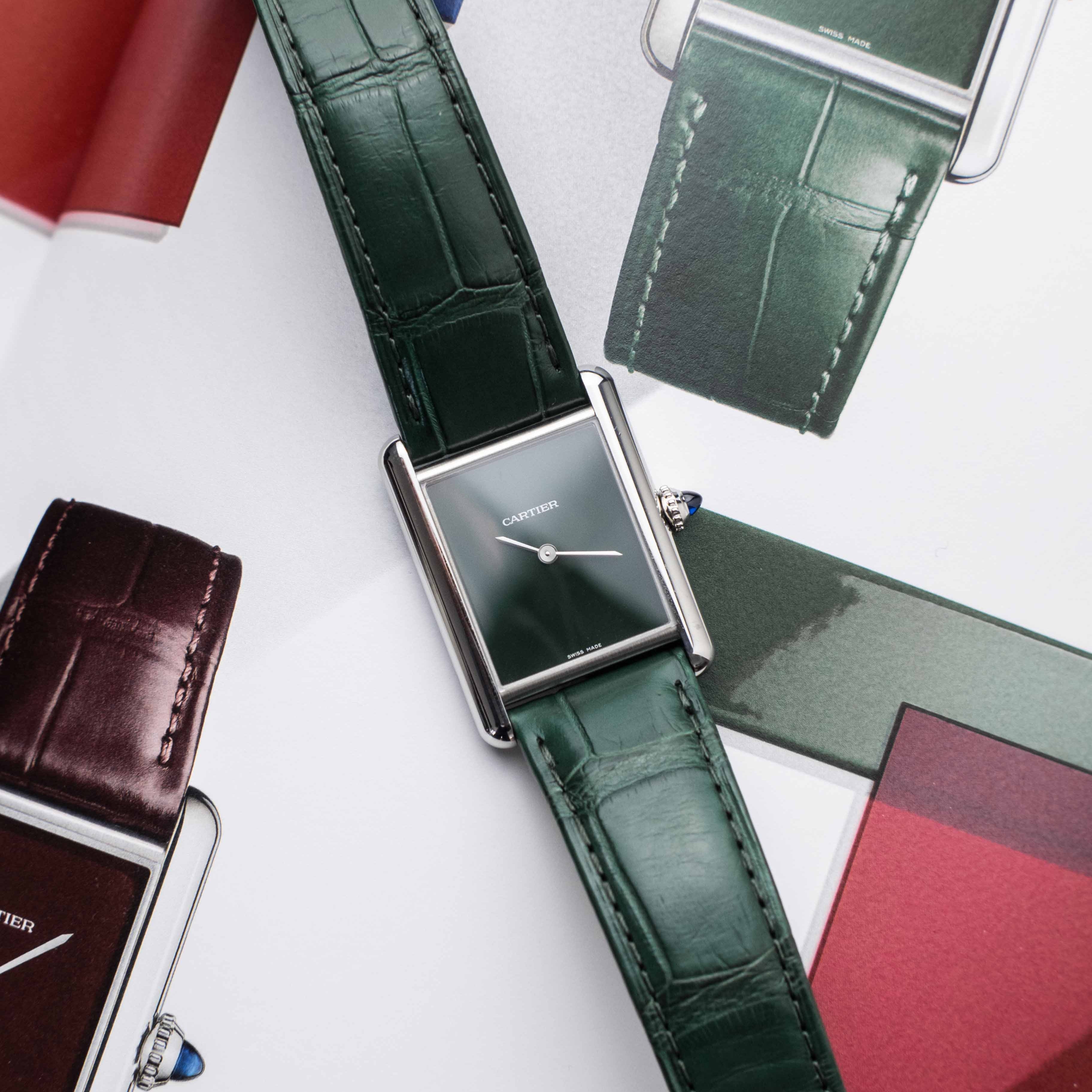 Cartier watches with green leather straps on a white background