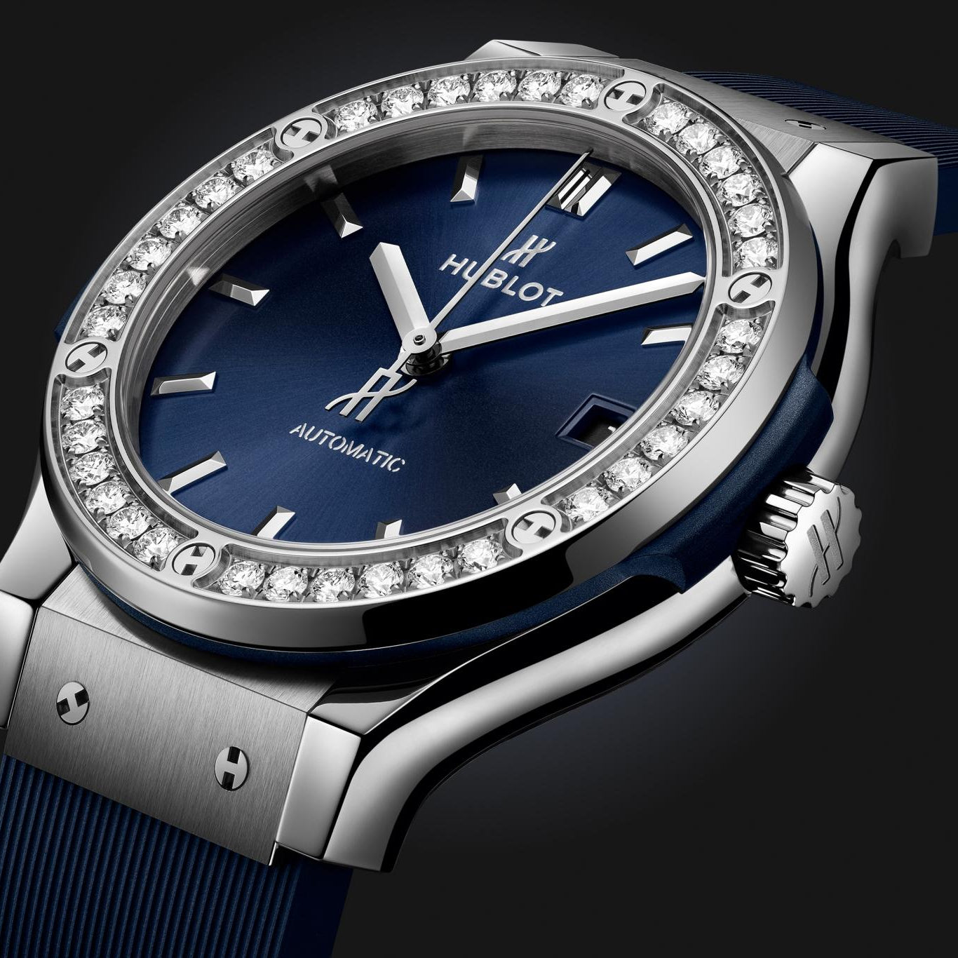 Hublot watch with blue face and diamond-studded bezel on a black background