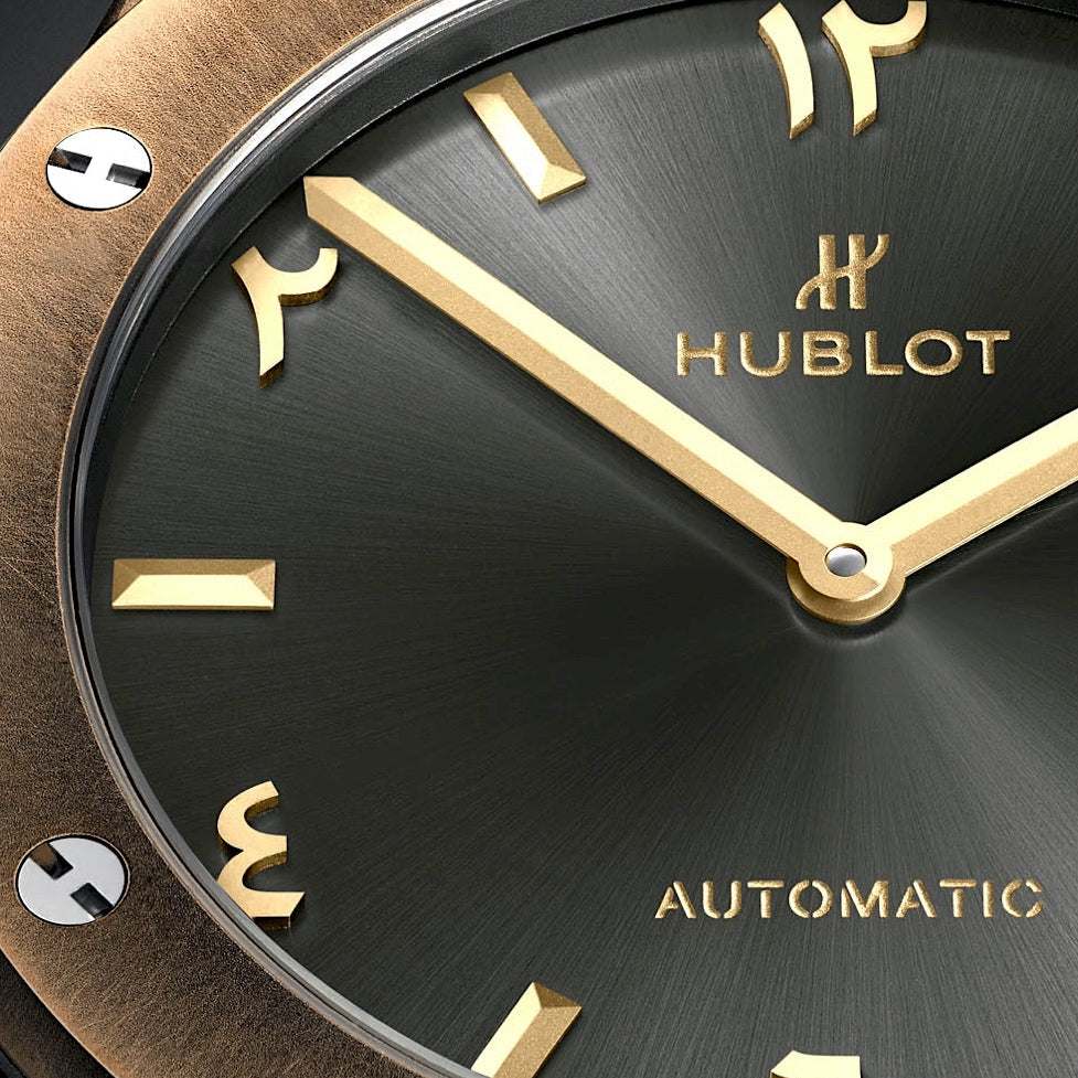 Close-up of a Hublot watch face with gold accents and 'Automatic' text.