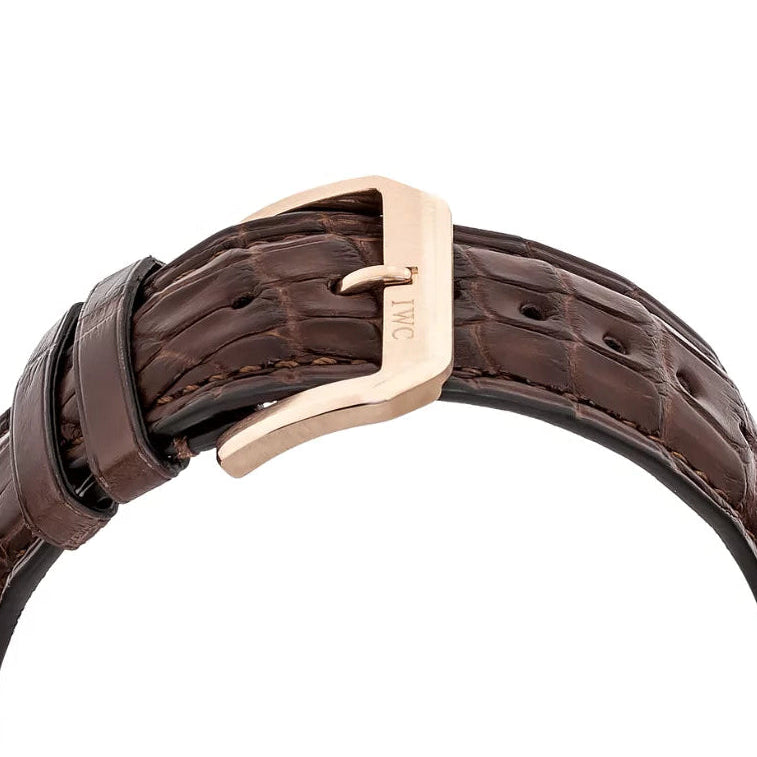 Brown leather belt with a rose gold buckle on a white background