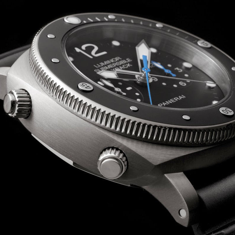 Luxury watch with black dial and rubber strap on a black background