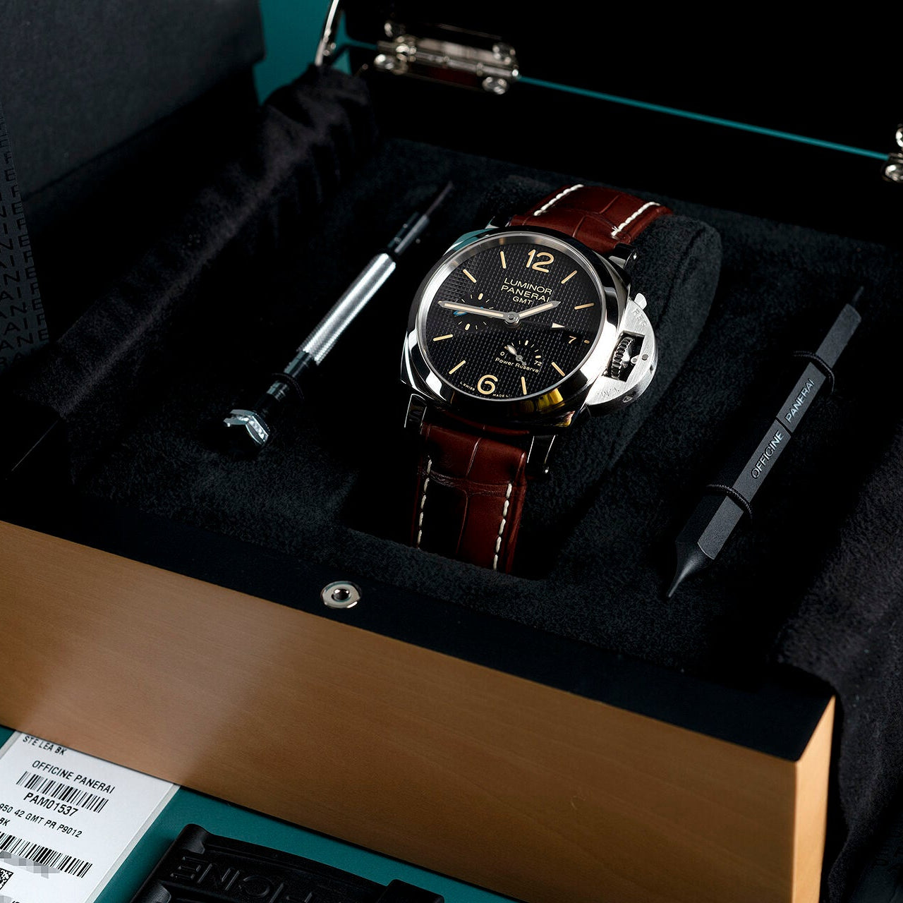Watch with brown leather strap in a black box with tools