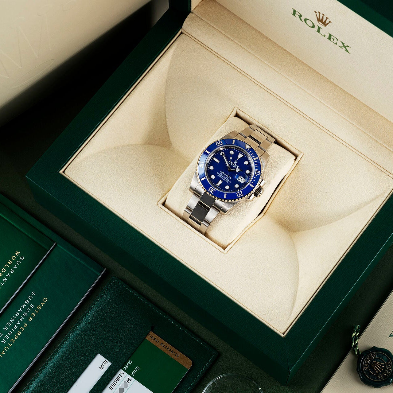 Rolex watch with blue dial in a green and beige box