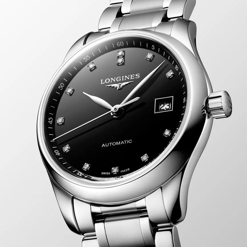 Longines watch with black dial and silver metal bracelet on a light gray background