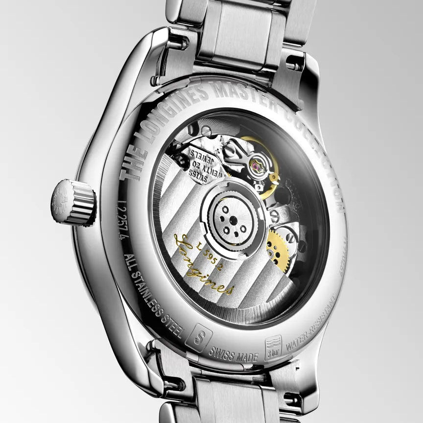 Silver watch with mechanical components on a light gray background