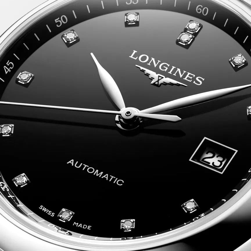 Longines watch with black dial and silver case on a white background