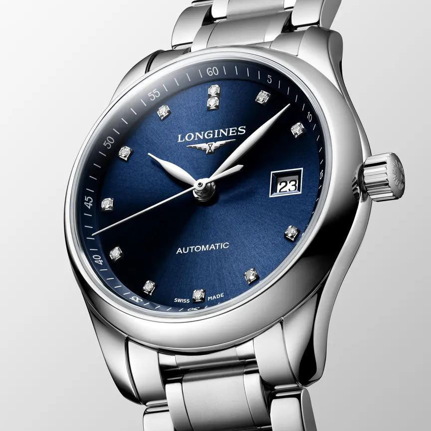 Longines watch with blue dial and silver bracelet on a light gray background