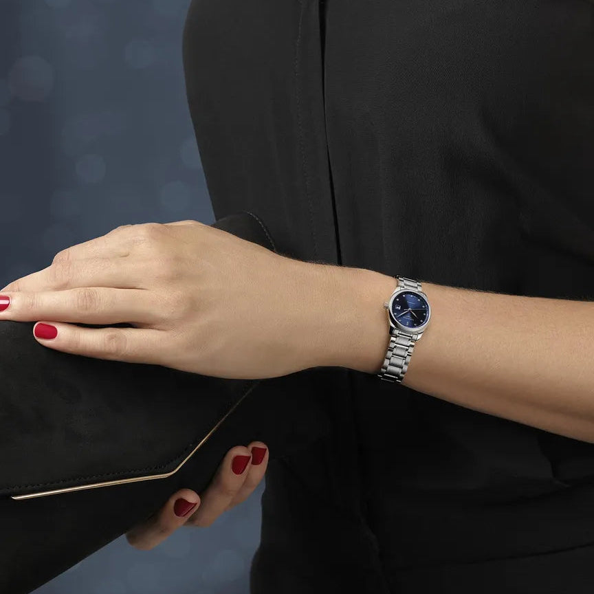 Person wearing a watch with a dark background