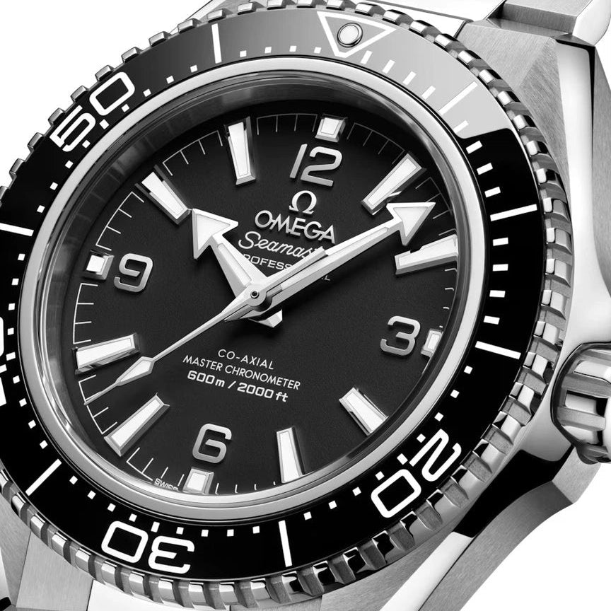 Silver Omega Seamaster watch with black dial on a white background