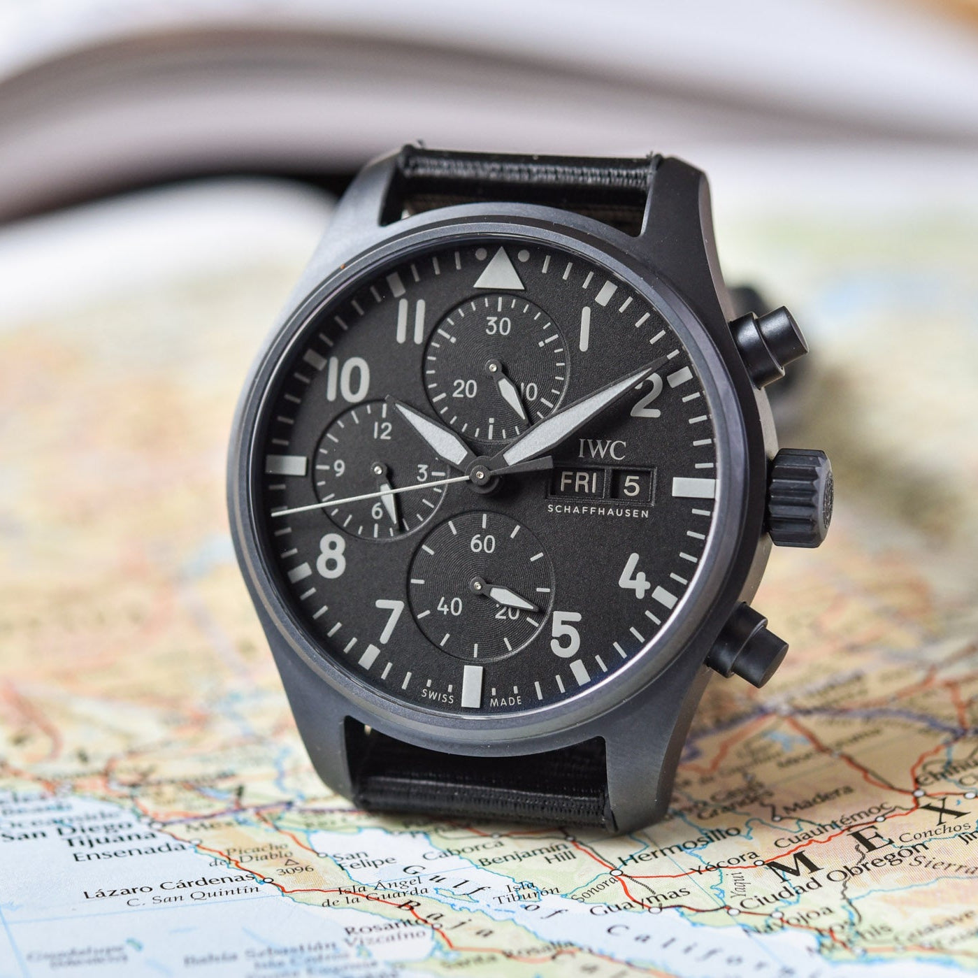 Black wristwatch on a map background