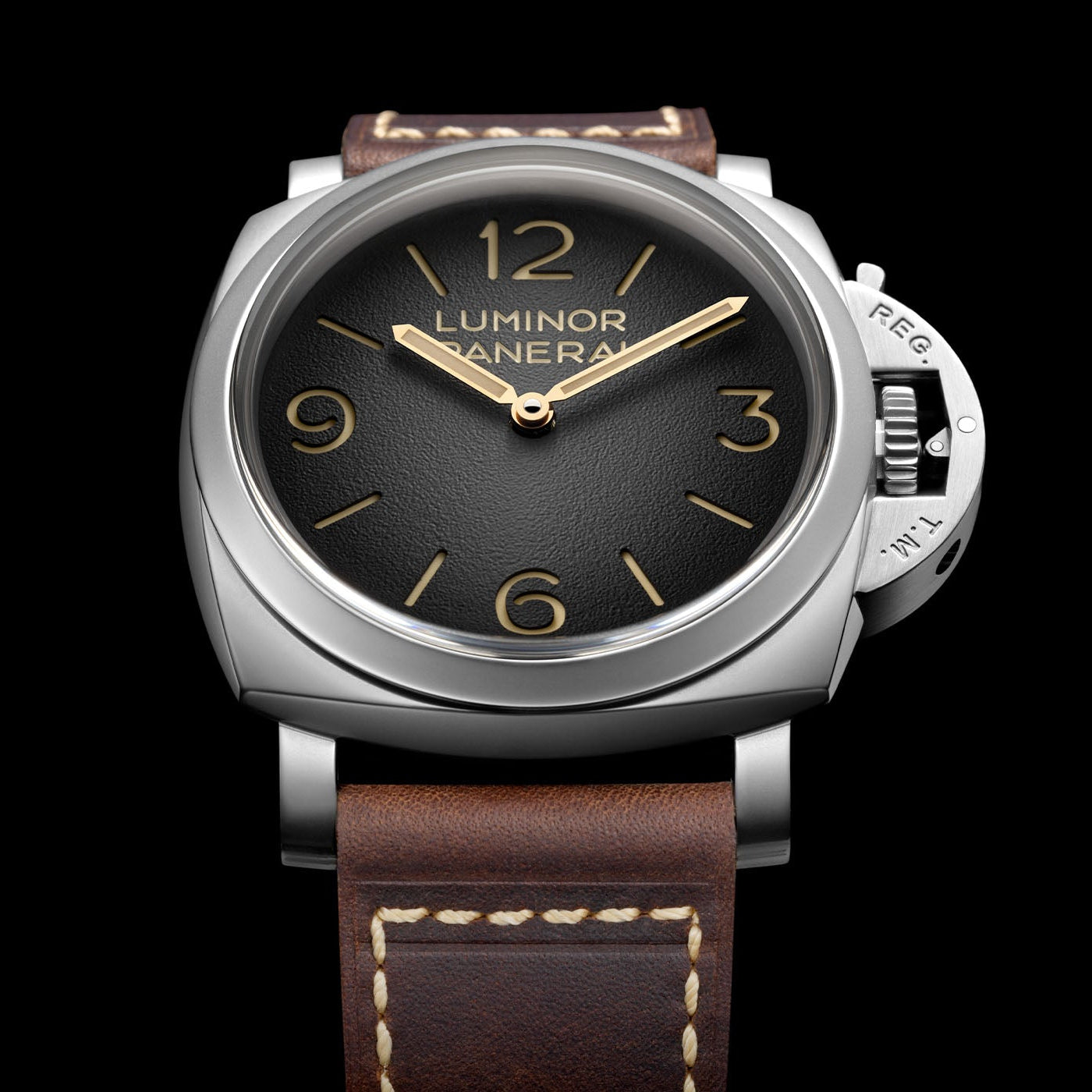 Luxury watch with brown leather strap and black dial on a black background