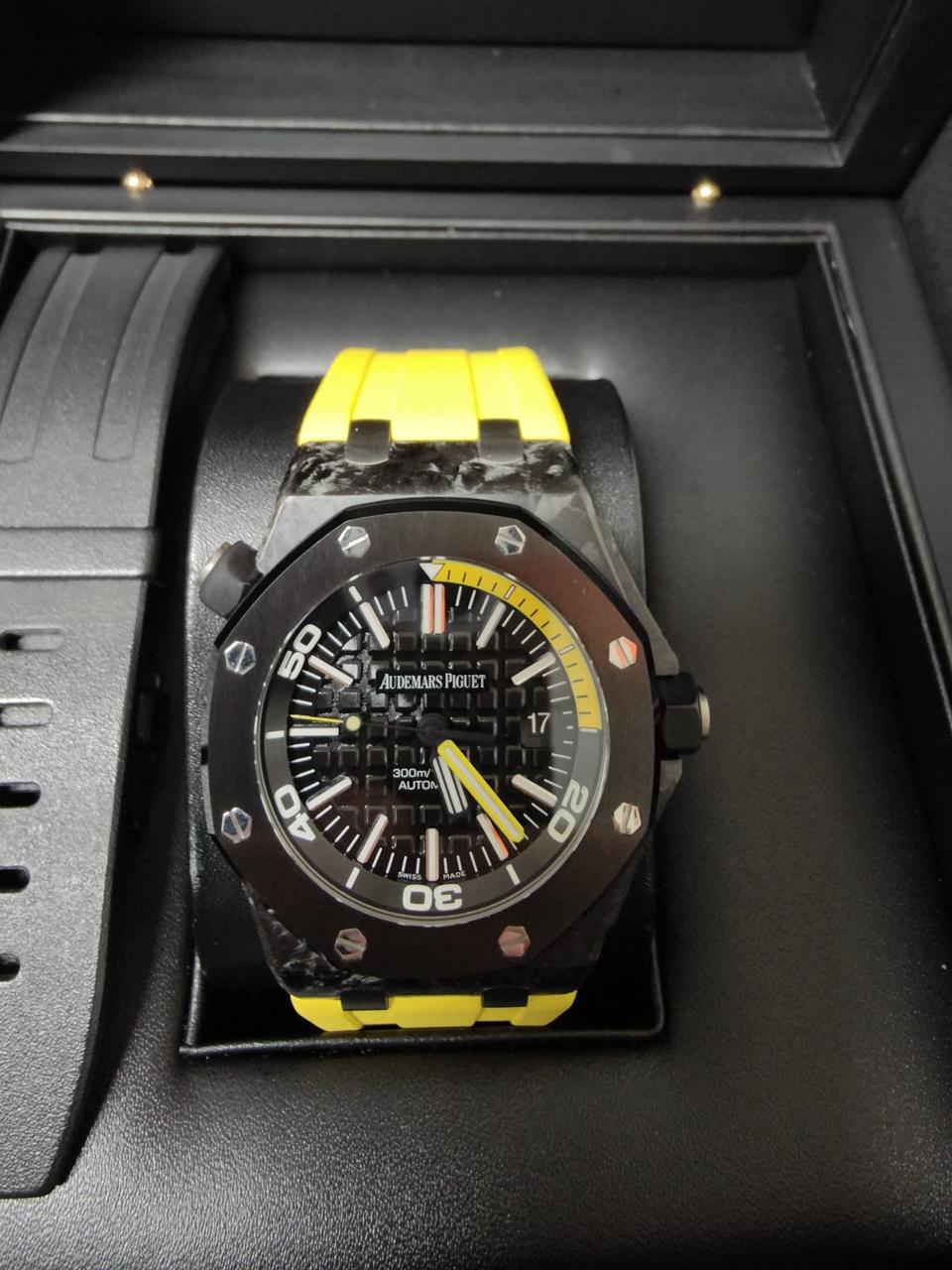 Luxury watch with black and yellow design in a display case