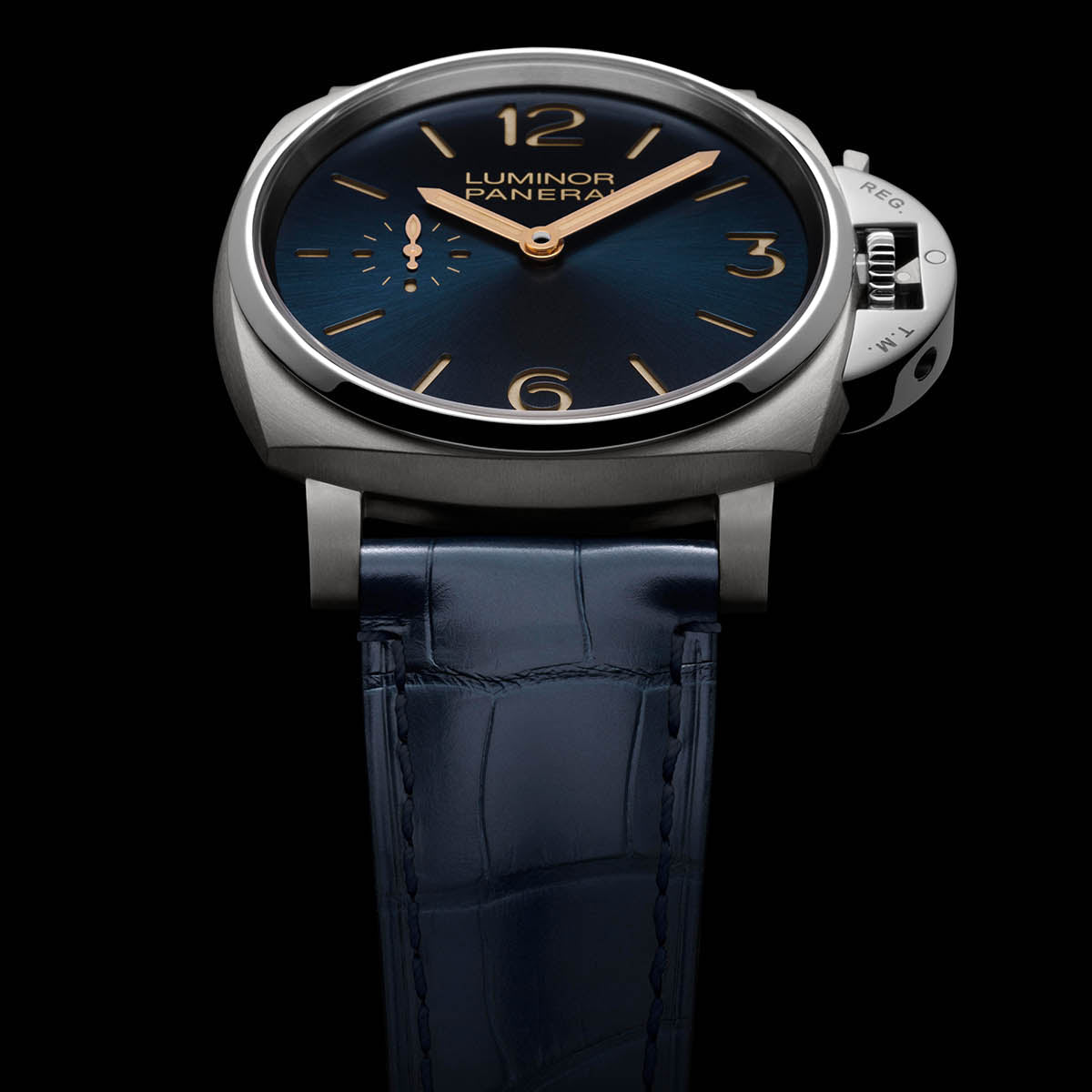 Luxury watch with blue strap and dark face on a black background
