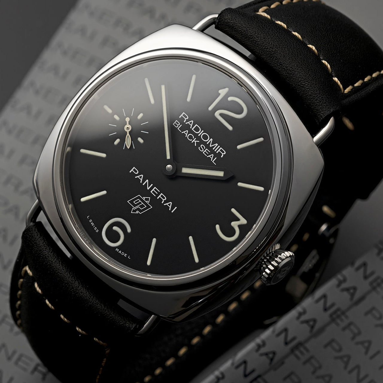Panerai watch with black dial and leather strap on a dark background